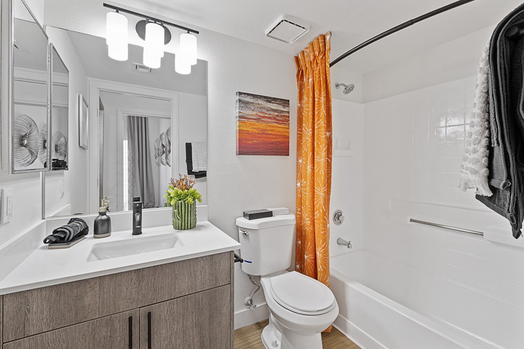 a bathroom with a toilet sink and tub and a shower