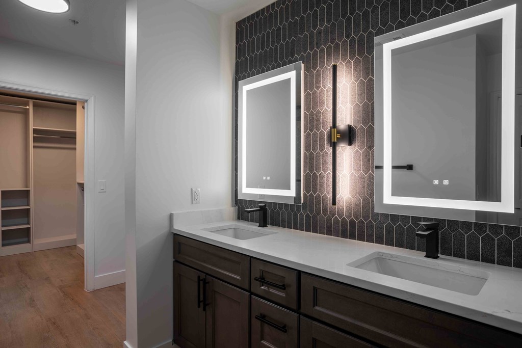 a bathroom with two sinks and a mirror