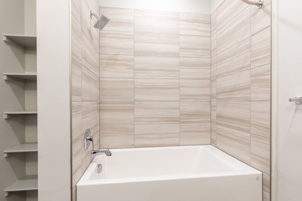 a bathroom with a bath tub and a shower curtain