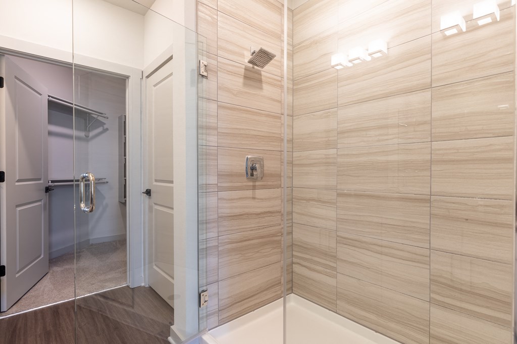 a large shower with a glass door in a bathroom