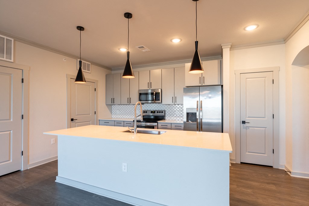 a kitchen with white cabinets and a white counter top