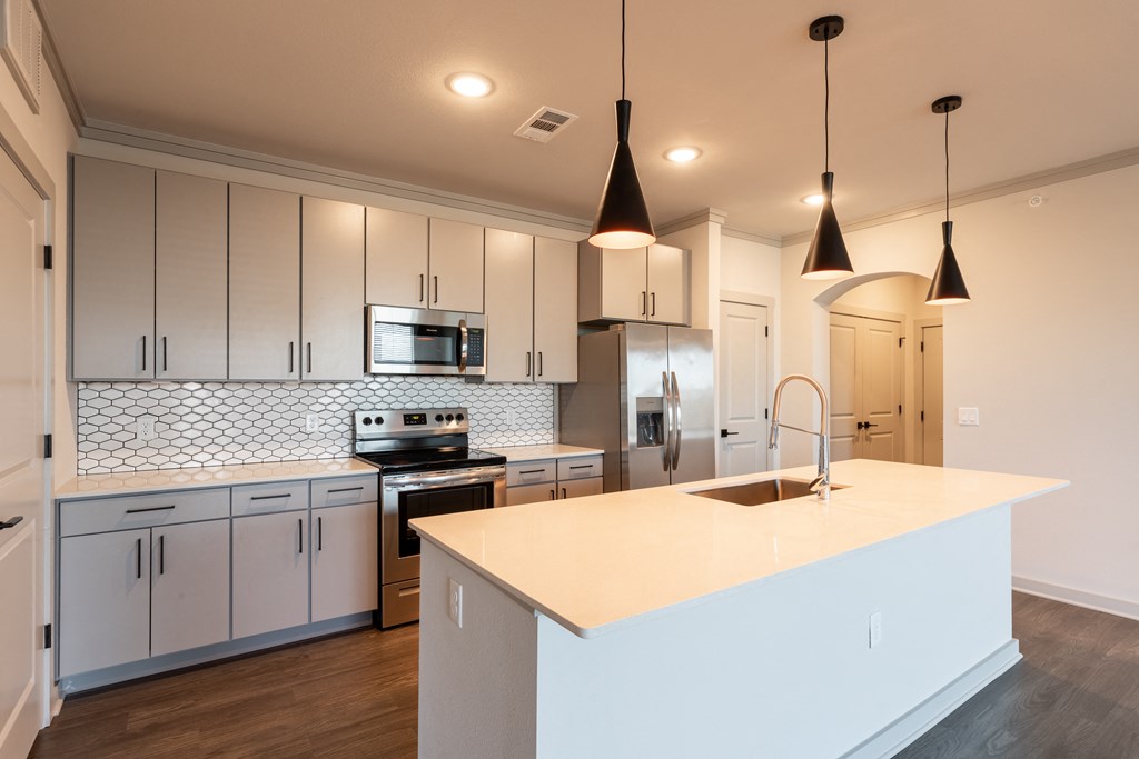 a kitchen with white cabinets and a white counter top