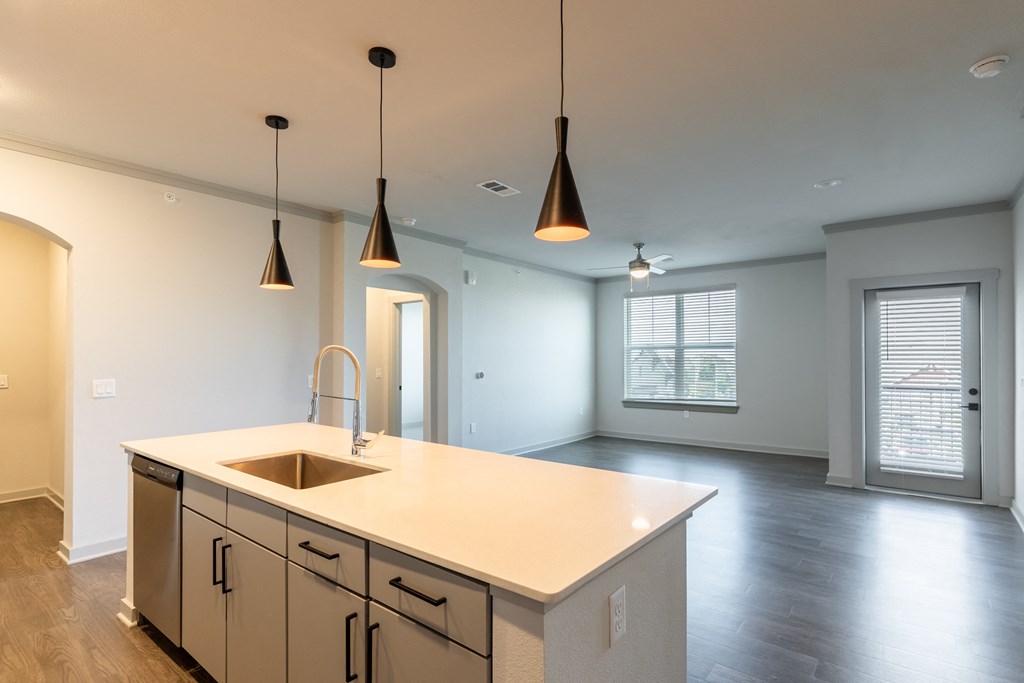 an empty kitchen with a large island in the middle