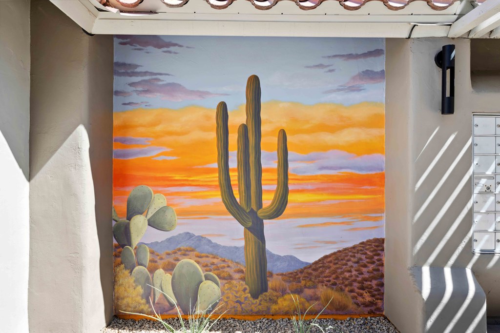 a mural of a saguaro cactus in the desert