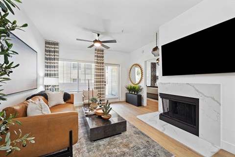 a living room with a fireplace and a large tv above it