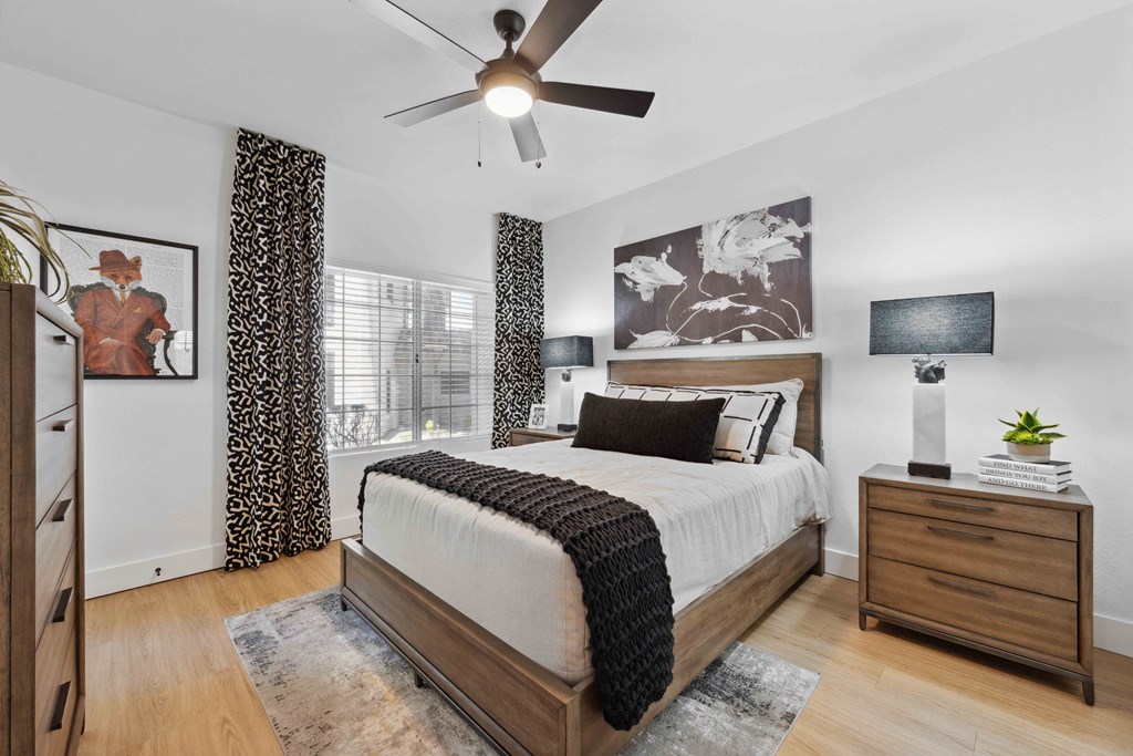 a bedroom with a large bed and a ceiling fan