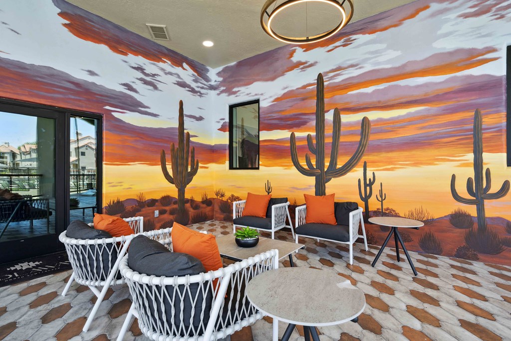 a patio with a mural of a desert sunset