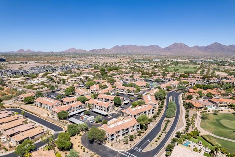 an aerial view of north scottsdale with houses and trees and mountains in the background