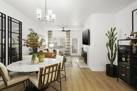 a living room and dining room with a table and chairs