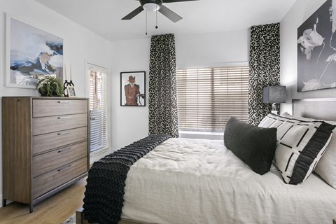 a bedroom with a bed and a ceiling fan