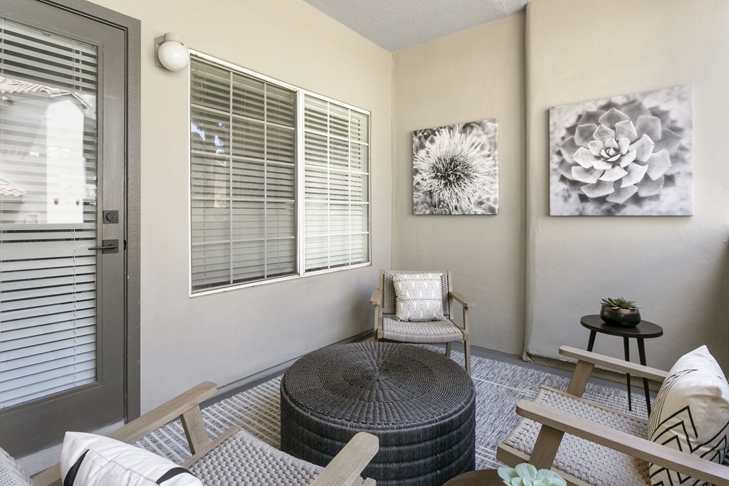 a living room with a chair and a table and a door