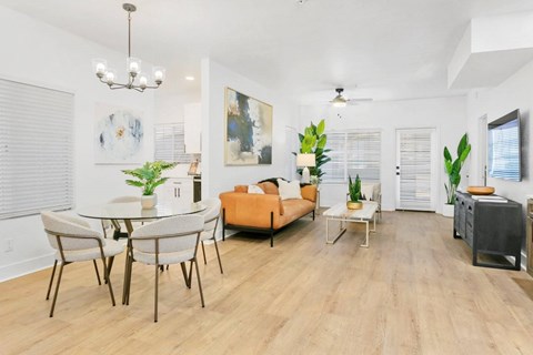 A living room with a dining table and chairs.