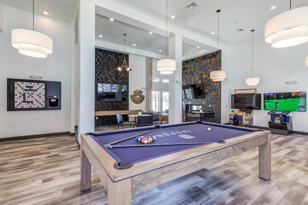 a community room with a pool table and a tv