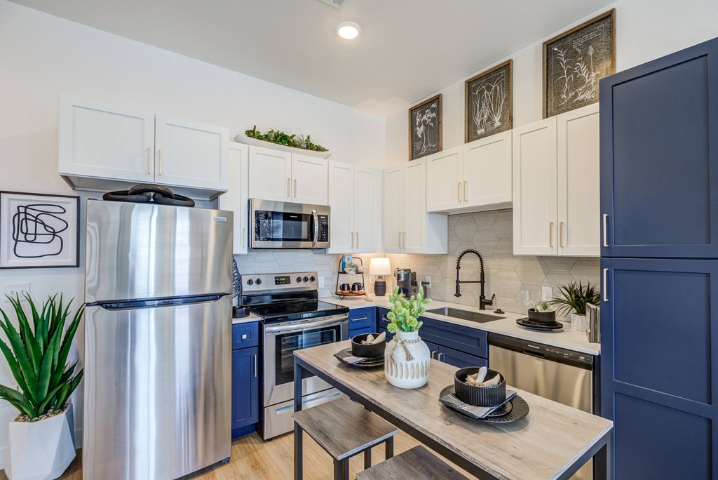 Contemporary kitchen featuring stainless steel appliances at Jasper at Victory Ridge luxury apartments Colorado Springs.