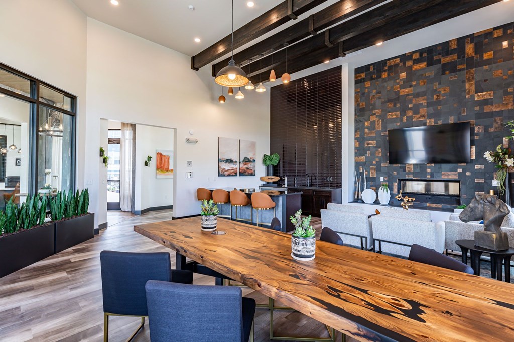 a living room with a wooden table and a fireplace