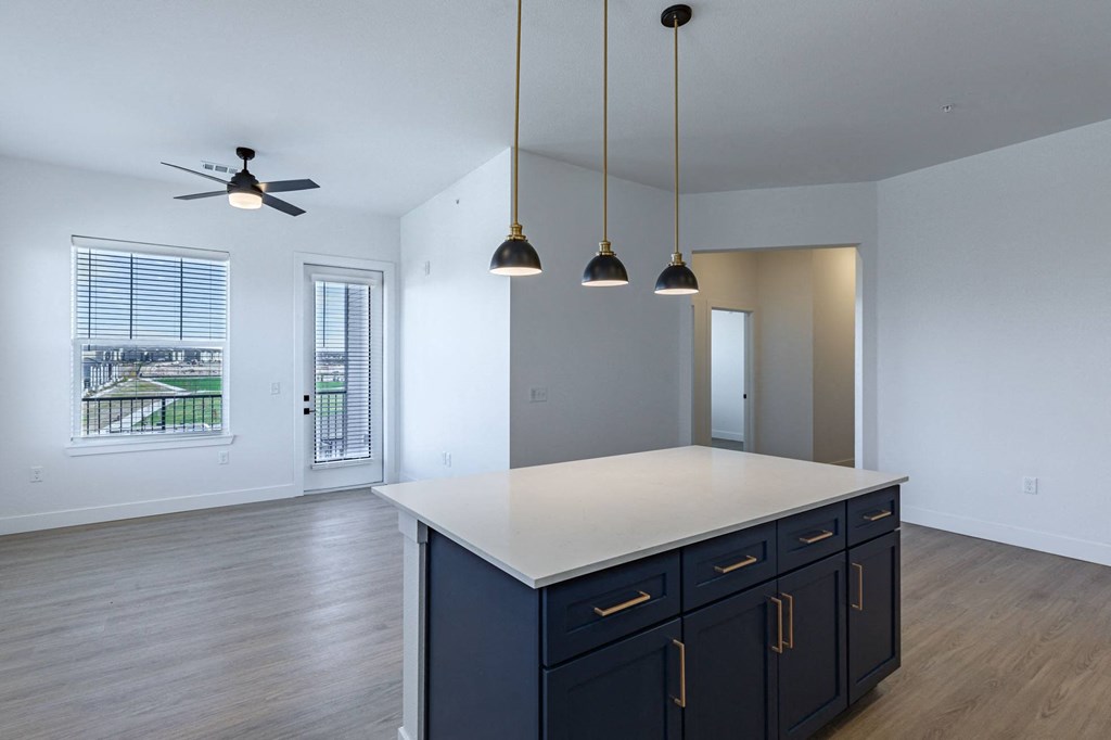 brand new kitchen with blue cabinets and modern hardware with ceiling fan