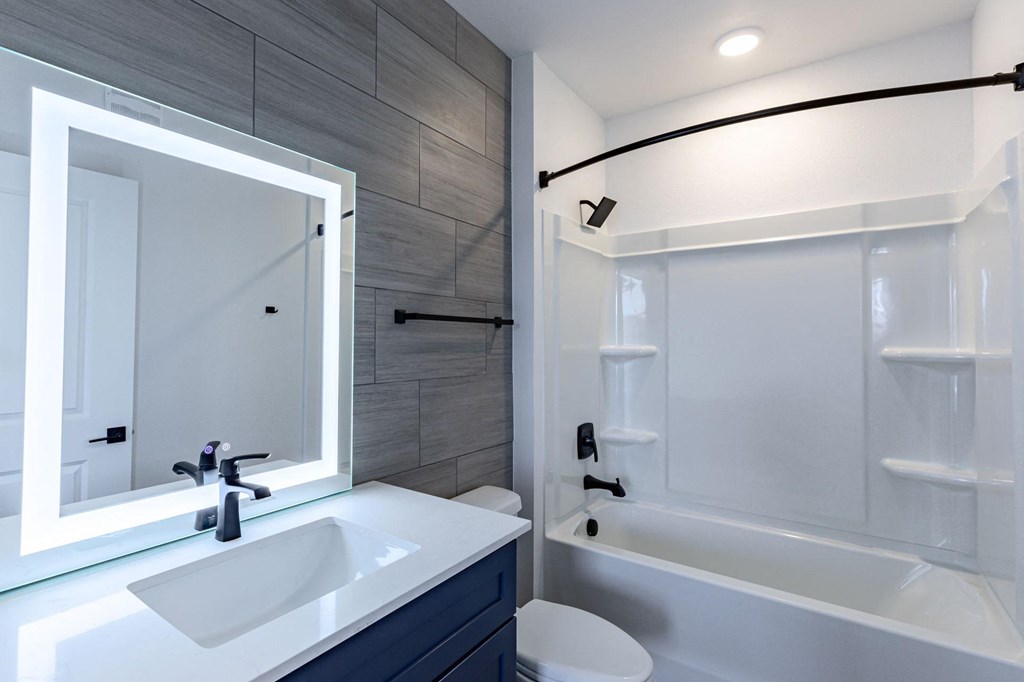 a bathroom with a sink and a shower and a bath tub