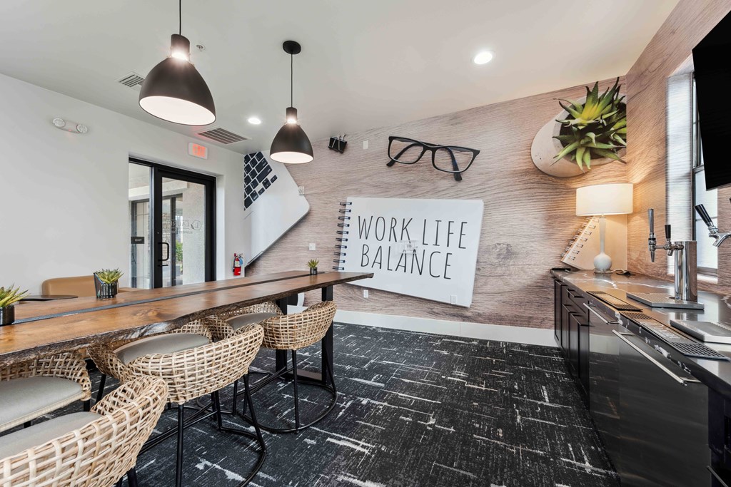 a conference room with a desk and chairs and a work life balance sign