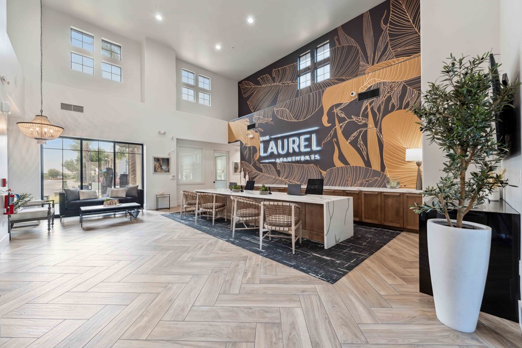 a lobby with a reception desk and a large wall mural