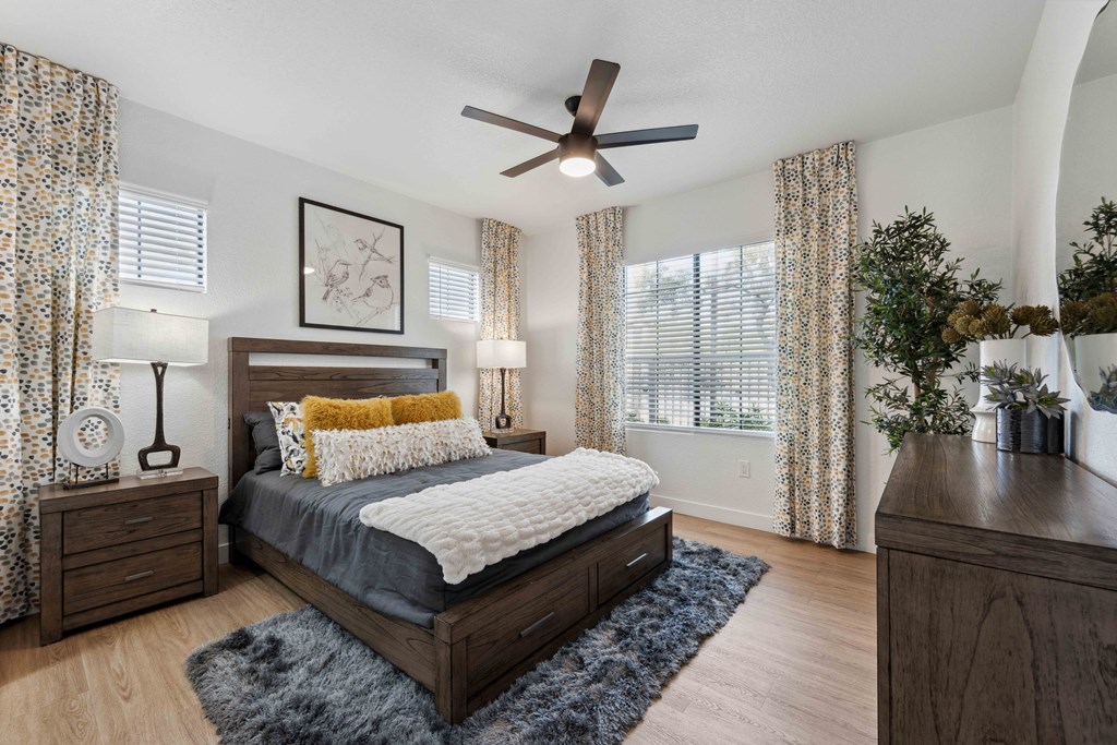 a bedroom with a bed and a ceiling fan