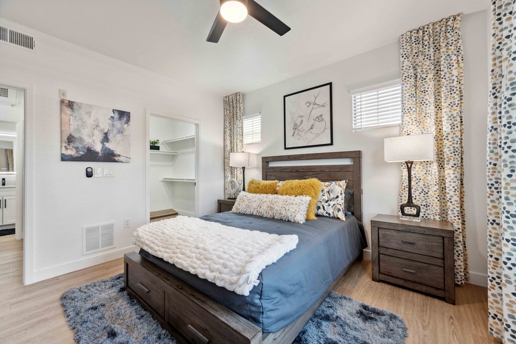 a bedroom with a bed and a ceiling fan