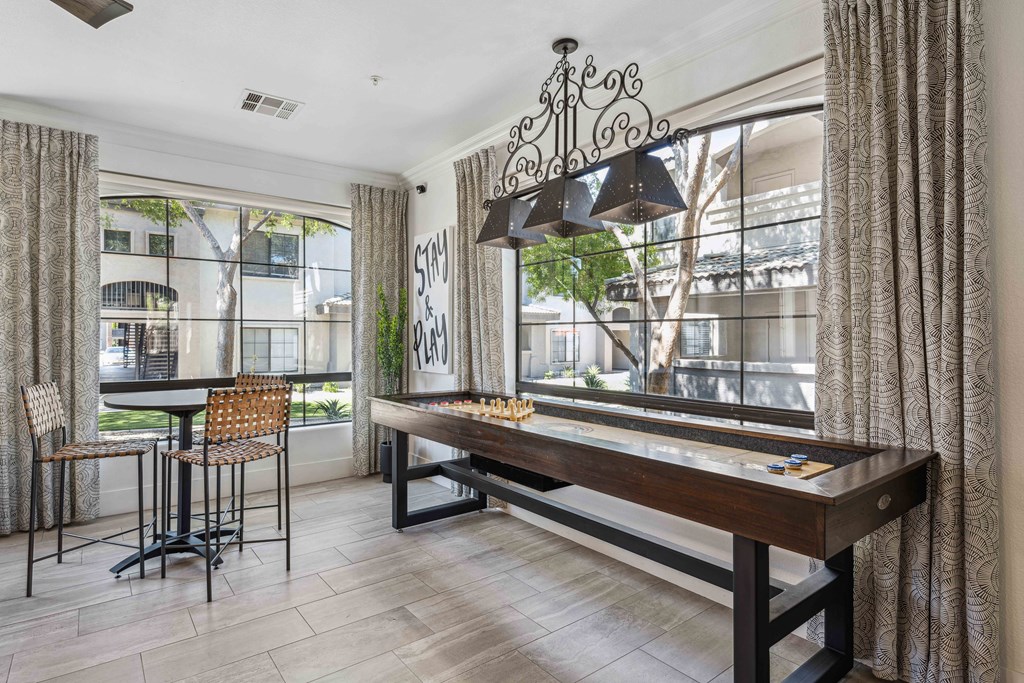 a game room with a foosball table and a bar