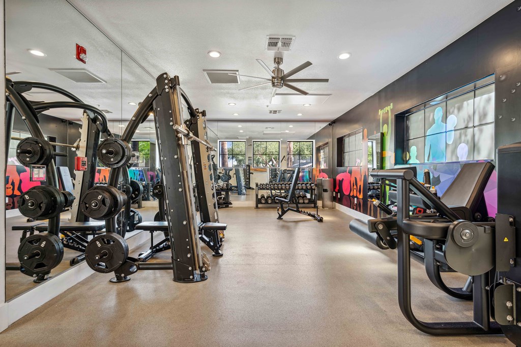 fitness center with a cardio hub and strength training room