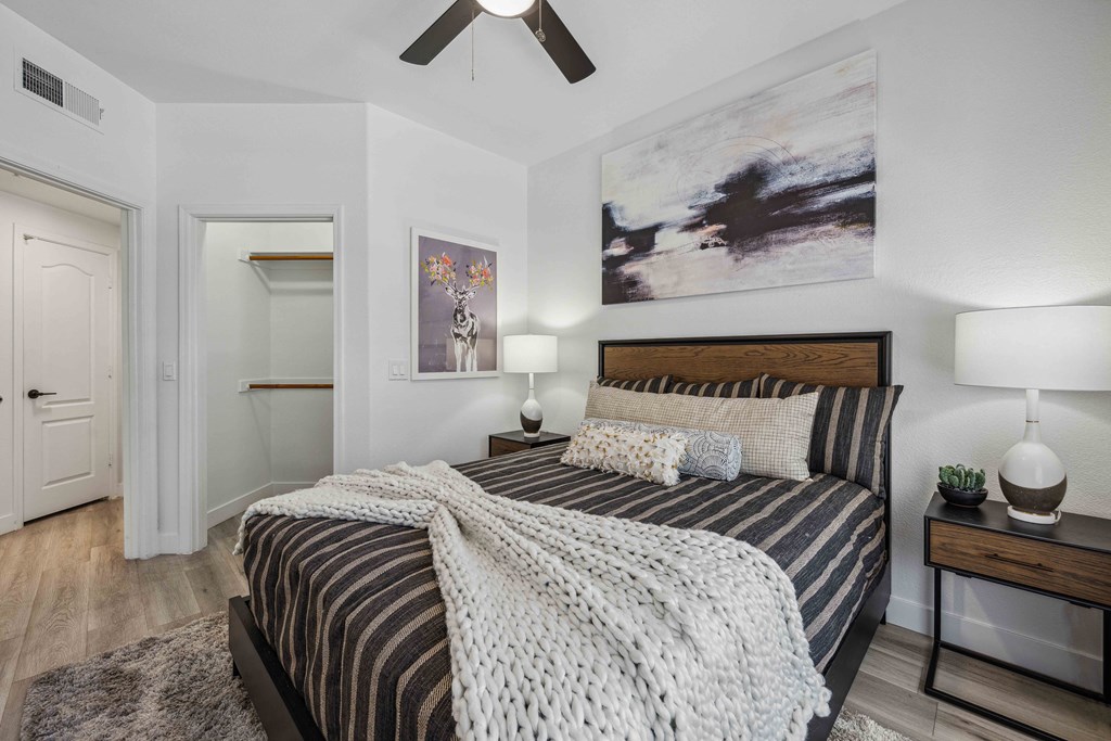 a bedroom with a bed and a ceiling fan