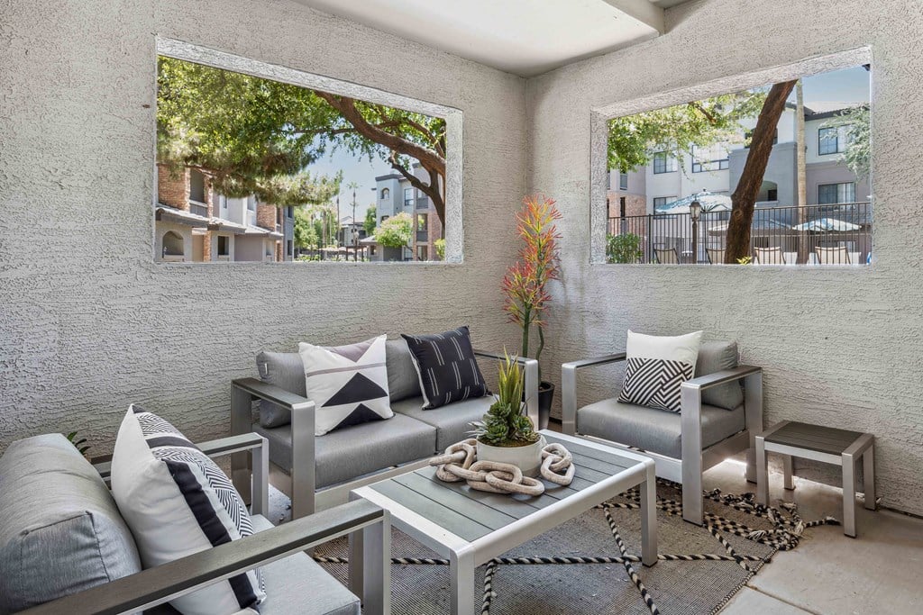 a patio with two couches and a coffee table