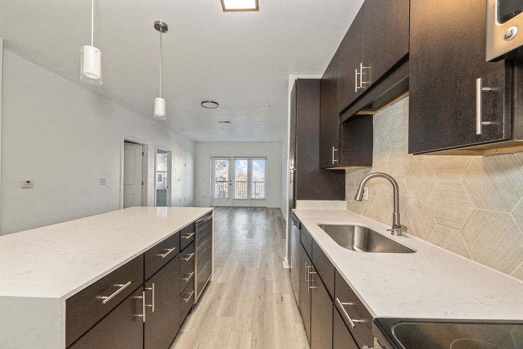a large kitchen with a sink and counter tops