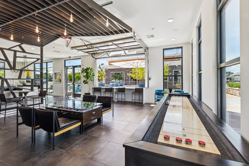 a game room with a foosball table and a ping pong table