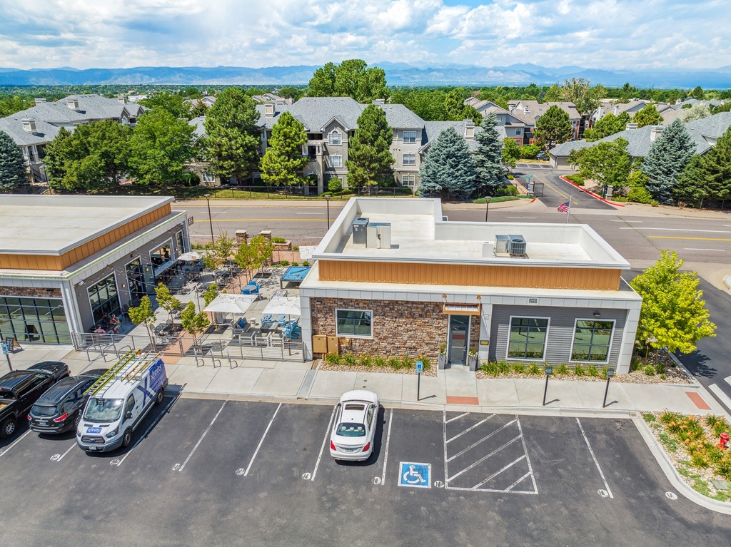a parking lot with cars in front of a building
