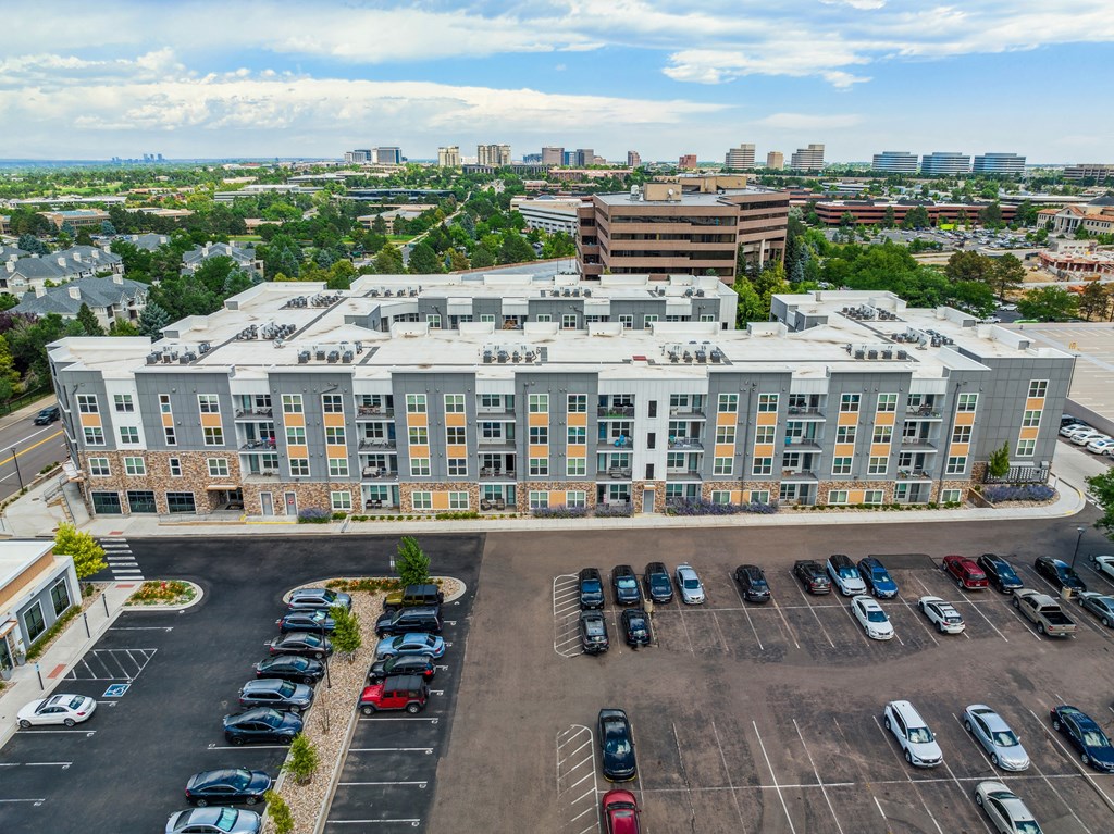 an aerial view of a large building with a parking lot in front of it