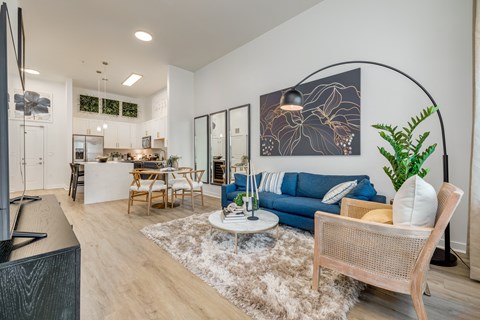 a living room with a blue couch and a table