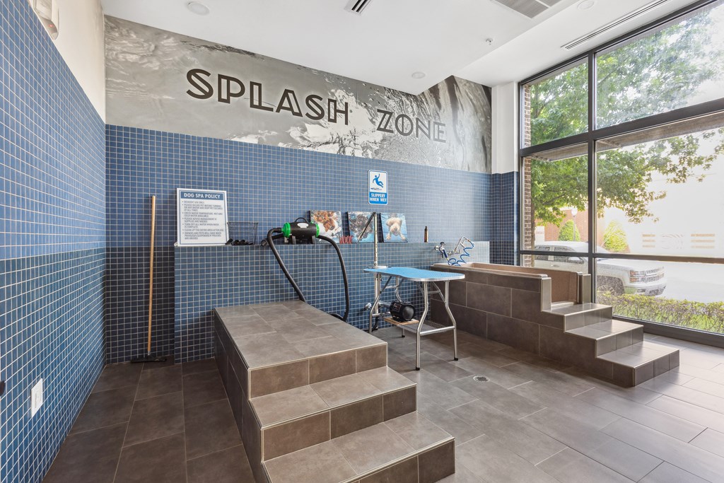 the entrance to thesplash zone with a bench and a table with a water hose