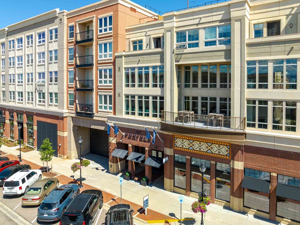 a view of a building from above with cars parked in front of it