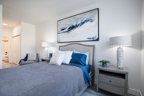a bedroom with a large bed with blue and white pillows