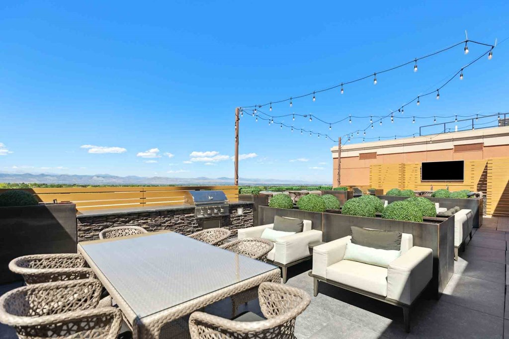 an outdoor patio with chairs and a table with a view of a field