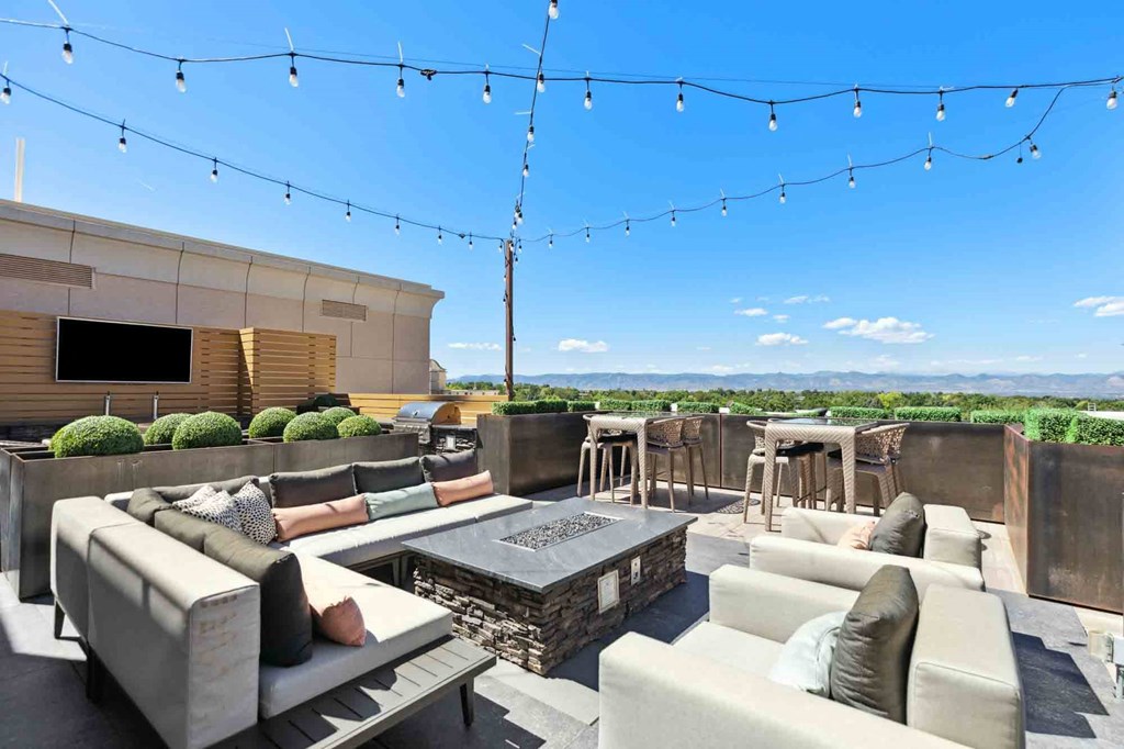 an outdoor patio with couches and a firepit
