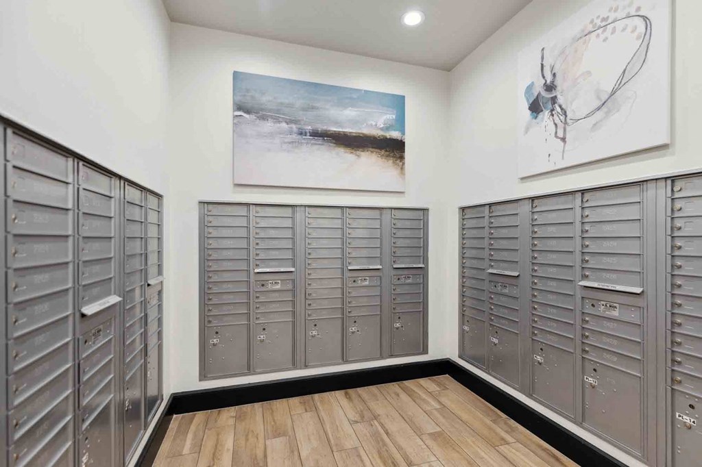 a large number of lockers in a room with a painting on the wall