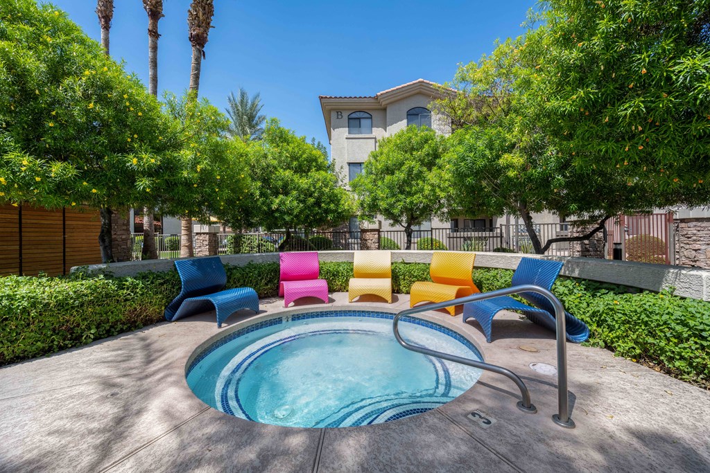 a hot tub with colorful chairs at san portella