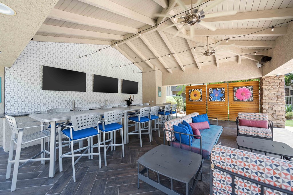 a patio with tables and chairs and a bar