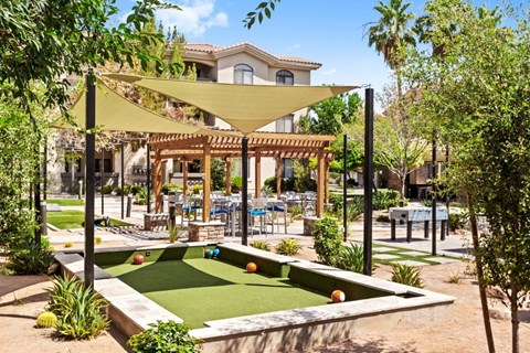 A backyard with a pool table and a patio area.