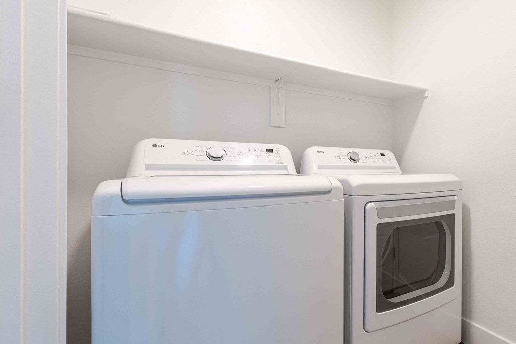 a washer and dryer in a laundry room with white walls