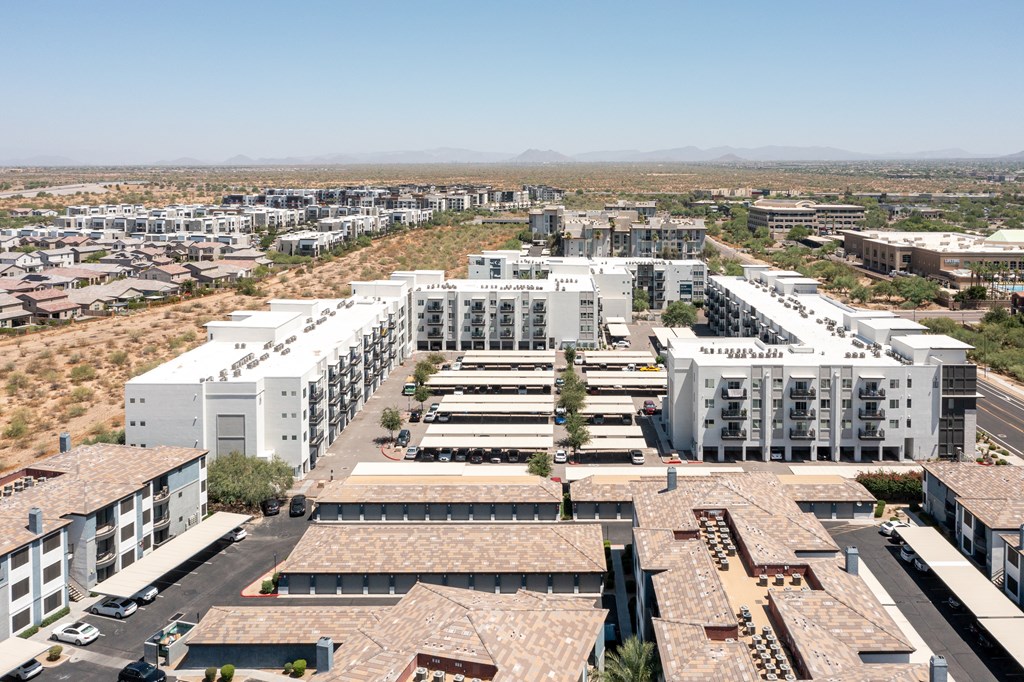 a cityscape of white buildings with a desert in the background