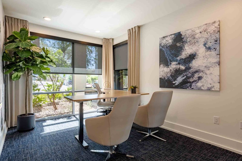 desk and chairs in conference room at slate scottsdale apartments