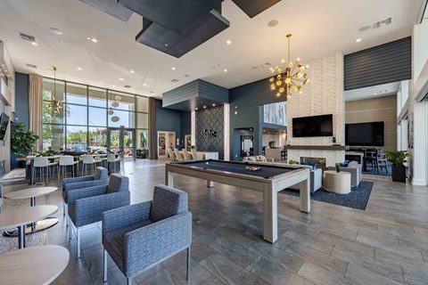 a spacious lobby with a pool table and lounge area