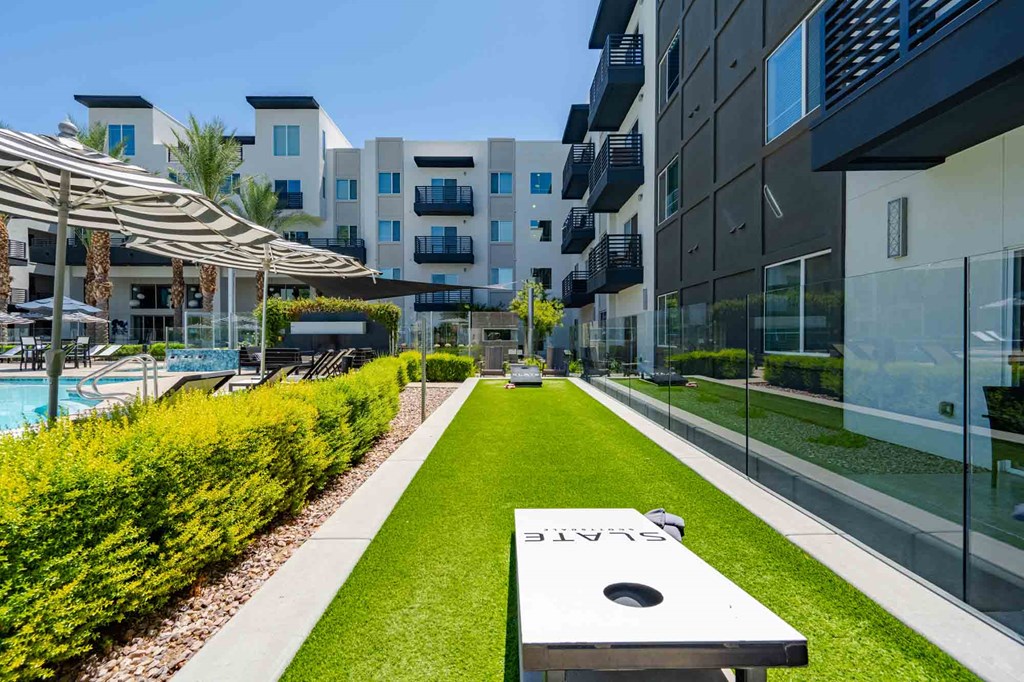 a backyard with a hot tub and grassy area