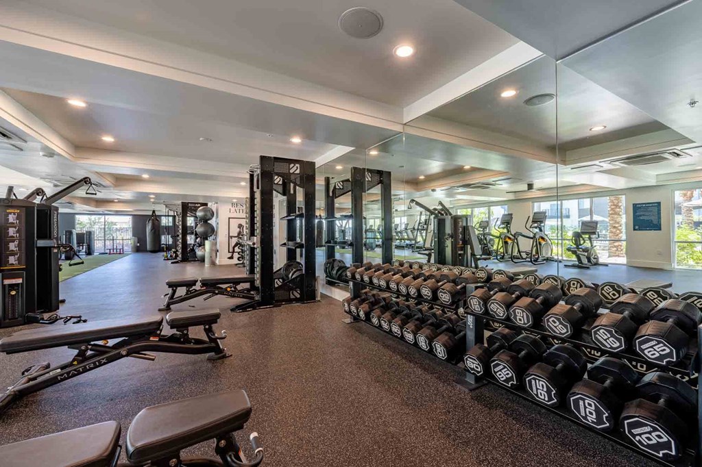 a spacious fitness center with weights and other exercise equipment