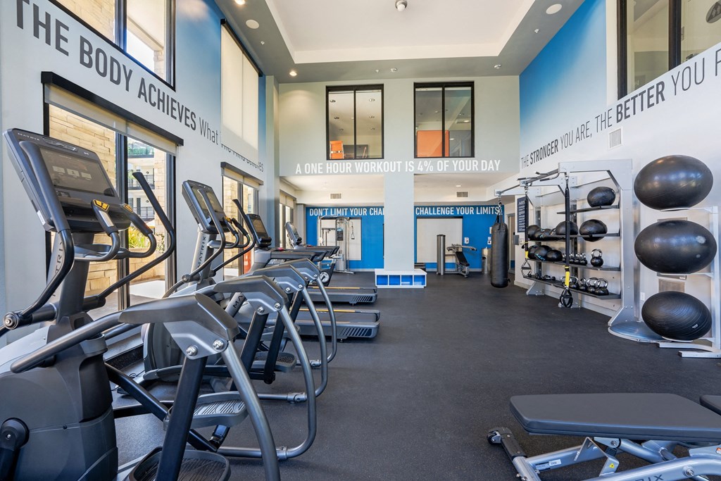 a fitness center with cardio equipment and weights in a gym